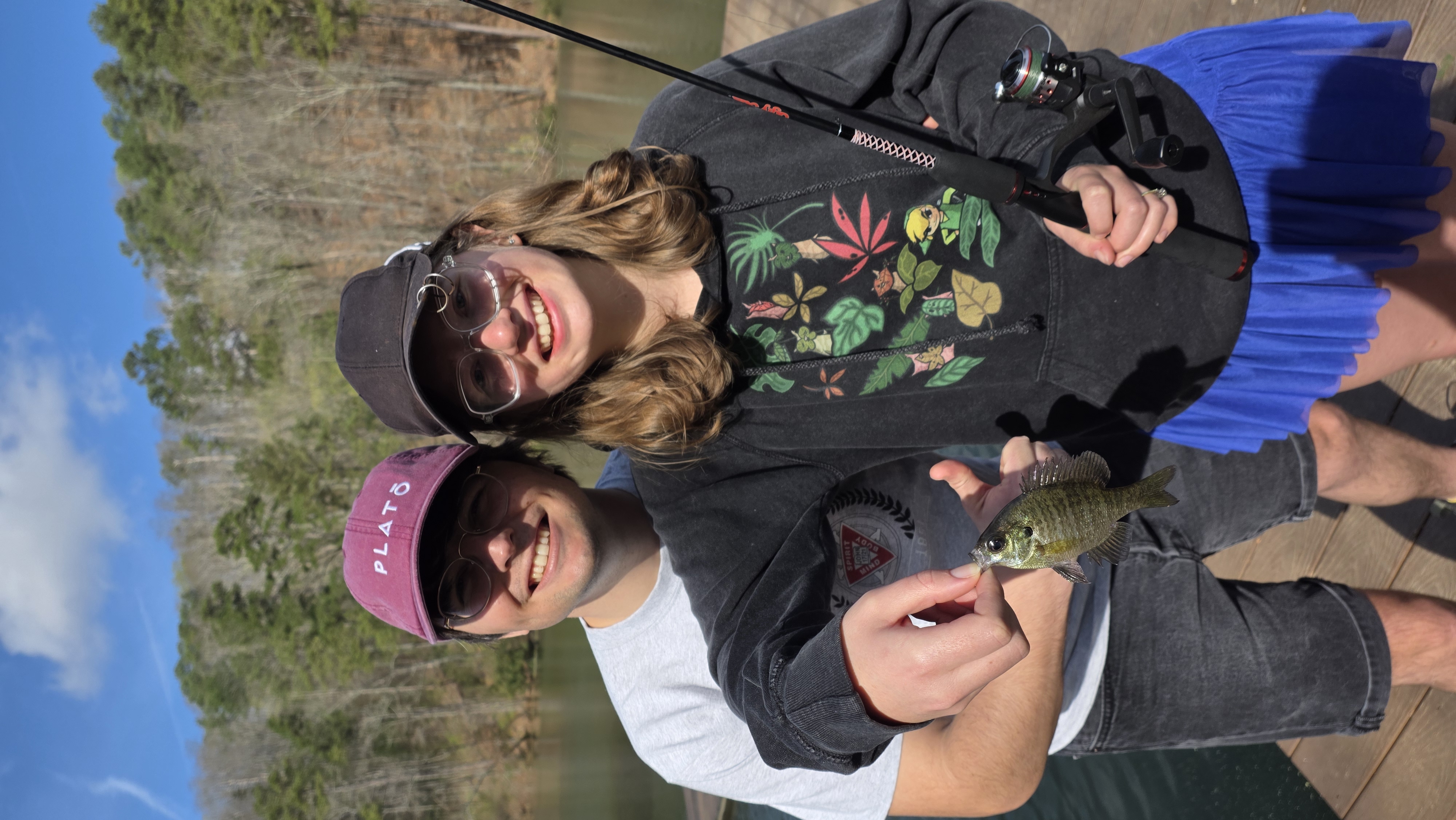 Jessica proudly holding up a bluegill fish she caught.